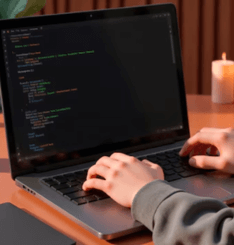 A person typing on a laptop