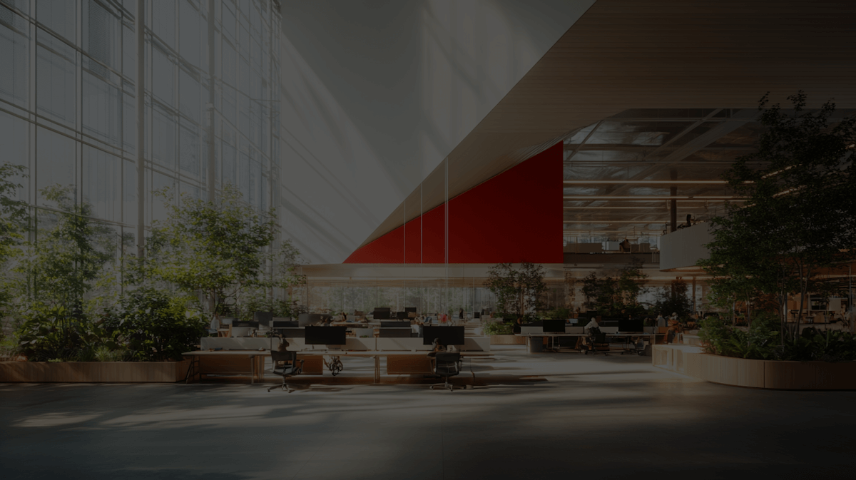 An expansive workspace filled with desks and lush plants